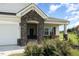 Front entry with stone pillars and a welcoming porch at 71 Nolan Ct, Lillington, NC 27546
