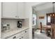 Kitchen features granite countertops and white cabinets at 71 Nolan Ct, Lillington, NC 27546