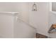 Modern staircase with dark metal railing and light wood flooring at 71 Nolan Ct, Lillington, NC 27546