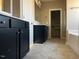 Spacious bathroom featuring double vanity with dark cabinets and a separate shower and tub at 981 Olive Branch Dr, Smithfield, NC 27577