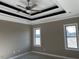 Bedroom with trey ceiling, ceiling fan, and dual windows offers natural light and comfort at 981 Olive Branch Dr, Smithfield, NC 27577