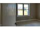 Bright bedroom features a window overlooking the yard; neutral walls and ample space at 981 Olive Branch Dr, Smithfield, NC 27577