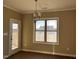 Bright dining room with large window and modern chandelier is perfect for Gathering meals at 981 Olive Branch Dr, Smithfield, NC 27577