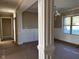 An open-concept entryway with decorative column and trim work, adjacent to a dining area at 981 Olive Branch Dr, Smithfield, NC 27577