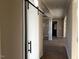 Hallway with sliding barn door and decorative molding, offering an open and welcoming feel at 981 Olive Branch Dr, Smithfield, NC 27577