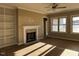 Spacious living area with built-in bookshelves, a ceiling fan, and a charming stone fireplace at 981 Olive Branch Dr, Smithfield, NC 27577