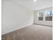 Well-lit bedroom with neutral walls and carpet at 448 La Maison Ave # 19, Wendell, NC 27591