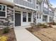 Townhome's front entrance with stone and gray siding at 448 La Maison Ave # 19, Wendell, NC 27591