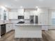 Modern kitchen with white cabinets, granite countertops, and stainless steel appliances at 448 La Maison Ave # 19, Wendell, NC 27591