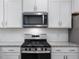Stainless steel range and microwave in modern kitchen at 448 La Maison Ave # 19, Wendell, NC 27591