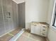 Bathroom features tiled shower with a built-in niche and a vanity with storage at 7208 Tanbark Way, Raleigh, NC 27615