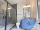 Modern bathroom featuring a walk-in shower with grey tile, and double vanity at 7208 Tanbark Way, Raleigh, NC 27615