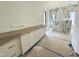Bathroom featuring marble tile, double sink vanity, and modern fixtures at 7208 Tanbark Way, Raleigh, NC 27615