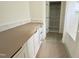 Bathroom vanity with countertop and view into shelved closet and tiled shower at 7208 Tanbark Way, Raleigh, NC 27615