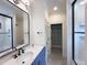 Modern bathroom with a large mirror, marble countertop, and walk-in shower at 7208 Tanbark Way, Raleigh, NC 27615