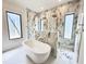 Modern bathroom featuring a freestanding tub and marble-tiled walk-in shower with dual shower heads at 7208 Tanbark Way, Raleigh, NC 27615