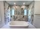 Modern bathroom with a freestanding soaking tub and exquisite marble tile shower with double shower heads at 7208 Tanbark Way, Raleigh, NC 27615