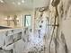 This modern bathroom features a frameless glass shower, marble tiling, and a soaking tub at 7208 Tanbark Way, Raleigh, NC 27615
