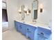 Bathroom featuring double sinks, framed mirrors, and decorative lighting fixtures at 7208 Tanbark Way, Raleigh, NC 27615