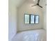 Bedroom with vaulted ceilings, ceiling fan and large windows at 7208 Tanbark Way, Raleigh, NC 27615
