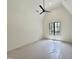Bedroom with vaulted ceilings, ceiling fan and a large window providing natural light at 7208 Tanbark Way, Raleigh, NC 27615