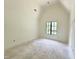 Bedroom with a large window providing natural light and neutral walls at 7208 Tanbark Way, Raleigh, NC 27615