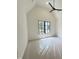 Bedroom with vaulted ceilings, ceiling fan and large windows at 7208 Tanbark Way, Raleigh, NC 27615