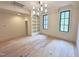 Bedroom featuring hardwood floors, a built-in bookshelf, and natural light from black-framed windows at 7208 Tanbark Way, Raleigh, NC 27615