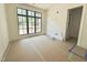 Bright bedroom featuring a large window with black trim and white walls at 7208 Tanbark Way, Raleigh, NC 27615