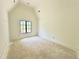 Bedroom with a large window providing natural light and neutral walls at 7208 Tanbark Way, Raleigh, NC 27615