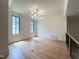 Bonus room features hardwood floors, natural light, and modern chandelier at 7208 Tanbark Way, Raleigh, NC 27615