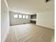 Unfinished bonus room featuring built-in cabinets, natural lighting, and neutral paint at 7208 Tanbark Way, Raleigh, NC 27615