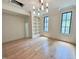 Bright bonus room features hardwood floors, natural light, built-in bookshelves and modern chandelier at 7208 Tanbark Way, Raleigh, NC 27615