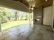 Spacious covered patio features an outdoor fireplace and view of the backyard at 7208 Tanbark Way, Raleigh, NC 27615