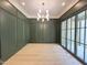 Elegant dining room featuring custom wall trim, contemporary lighting, and a large window at 7208 Tanbark Way, Raleigh, NC 27615