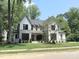 Beautiful two-story home with stone and siding details, lush green lawn at 7208 Tanbark Way, Raleigh, NC 27615