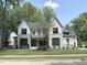 Beautiful two-story home with a manicured lawn, a stone and siding exterior, and a tree in the front yard at 7208 Tanbark Way, Raleigh, NC 27615