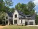 Beautiful two-story home featuring gray brick and siding, with a black roof and well-manicured lawn at 7208 Tanbark Way, Raleigh, NC 27615