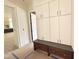 Hallway featuring cabinets and a bench with drawer storage near an open doorway at 7208 Tanbark Way, Raleigh, NC 27615