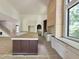Gourmet kitchen with a large island, custom cabinets, and view of the staircase at 7208 Tanbark Way, Raleigh, NC 27615