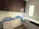 Kitchen with white cabinets, stainless steel appliances, and a window view at 7208 Tanbark Way, Raleigh, NC 27615