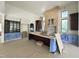 Spacious kitchen featuring white and dark wood cabinets, a large island, and unfinished accents at 7208 Tanbark Way, Raleigh, NC 27615