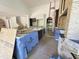 Kitchen with a dark wood center island, stainless steel appliances, and a view of the staircase at 7208 Tanbark Way, Raleigh, NC 27615