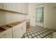 Laundry room with black and white tiled floor and built in washer/dryer hookups at 7208 Tanbark Way, Raleigh, NC 27615