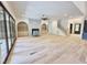 Spacious living room with fireplace, custom built-ins, light hardwood flooring and large glass doors at 7208 Tanbark Way, Raleigh, NC 27615