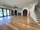 Bright and airy living area with hardwood floors, fireplace feature wall, a staircase, and sliding glass doors at 7208 Tanbark Way, Raleigh, NC 27615