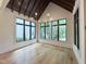Bright living room featuring large windows and hardwood floors at 7208 Tanbark Way, Raleigh, NC 27615