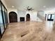 Open concept living area with hardwood floors, a decorative fireplace, large windows, and a staircase at 7208 Tanbark Way, Raleigh, NC 27615
