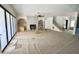Spacious living room with large windows, a fireplace, and open staircase at 7208 Tanbark Way, Raleigh, NC 27615