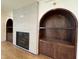Living room with fireplace and custom built in shelving on either side at 7208 Tanbark Way, Raleigh, NC 27615